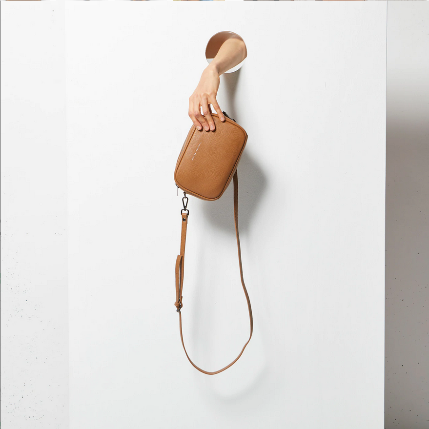 Status Anxiety Plunder Bag Tan Front Held Hanging By Hand | Merchants Homewares 